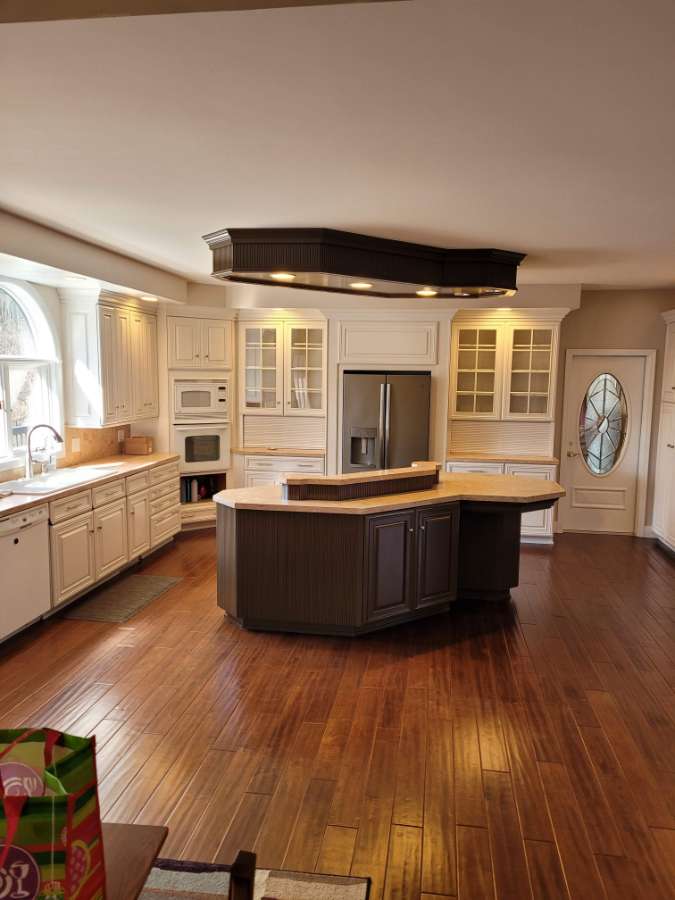 Spacious kitchen with center island and hardwood floors.